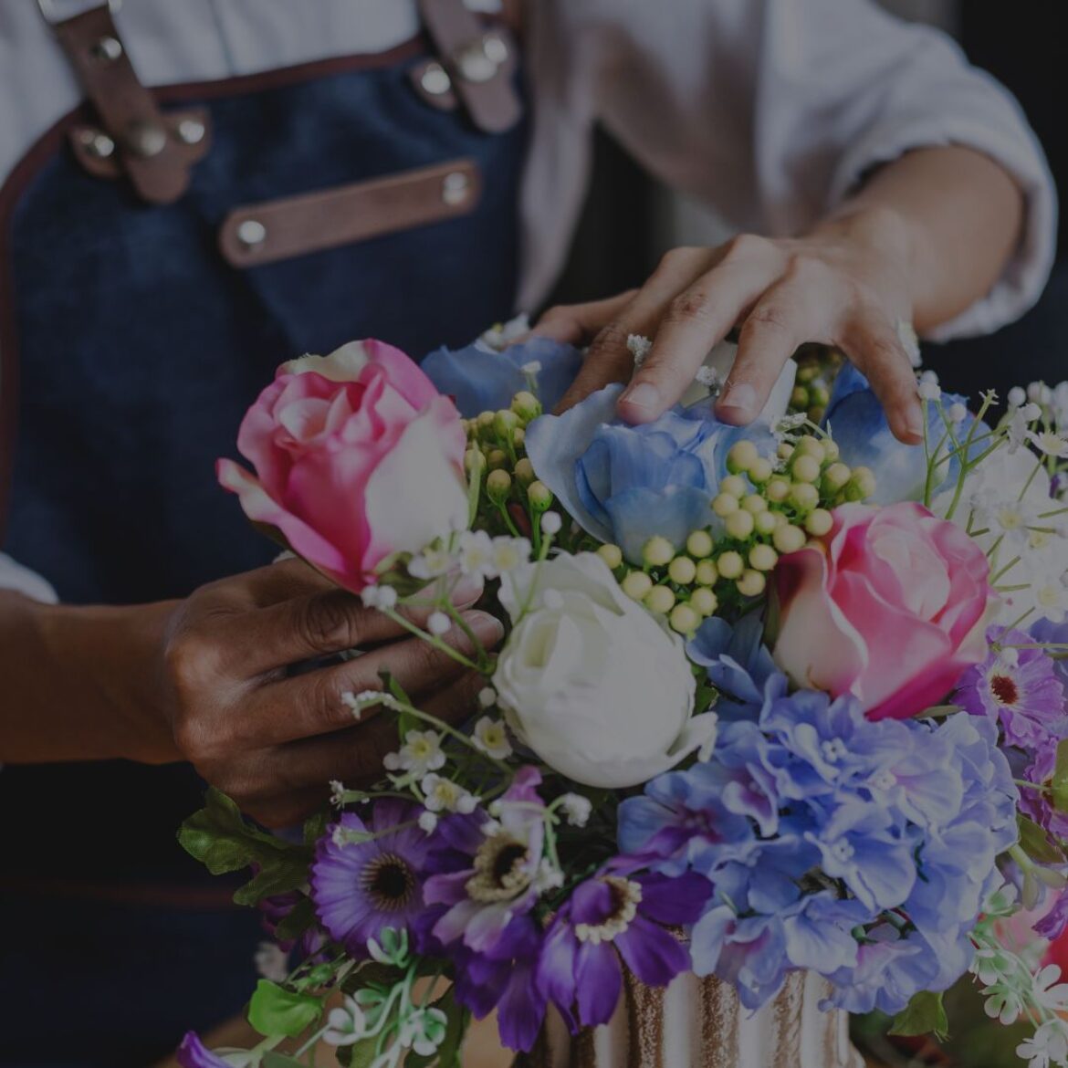 Small business owner arranging flowers