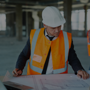 Construction worker looking at building plans